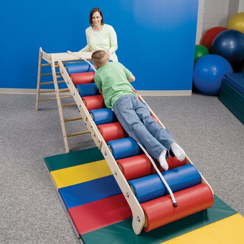 Southpaw Steamroller Ramp and Platform Set assembled indoors with an adult and child demonstrating proprioceptive input and heavy work activity in a therapy setting