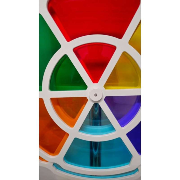 Close up of the LiteZilla ChromaWheel center hub where red, green, orange, yellow, blue and teal panels meet on this interactive color wheel