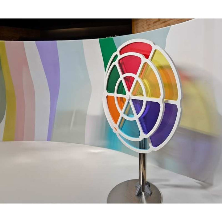 LiteZilla ChromaWheel interactive color wheel displayed on a showroom floor with a colorful backdrop, illustrating the STEM exhibit's scale