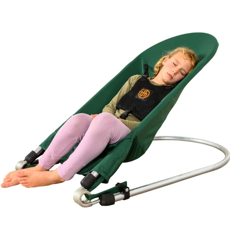 Side view of the TFH Bouncing Chair with child resting, illustrating seat depth and harness support for sensory regulation seating