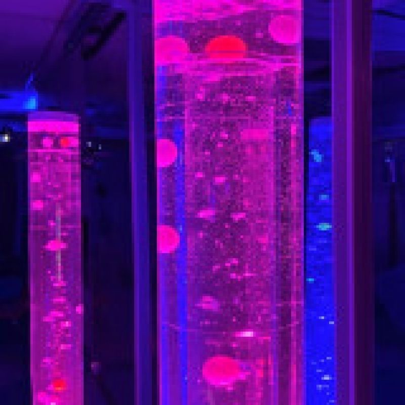 Close-up of TFH Standard Bubble Tube Insert showing cascading beads and balls in purple and blue LED light inside a 6-inch sensory bubble tube