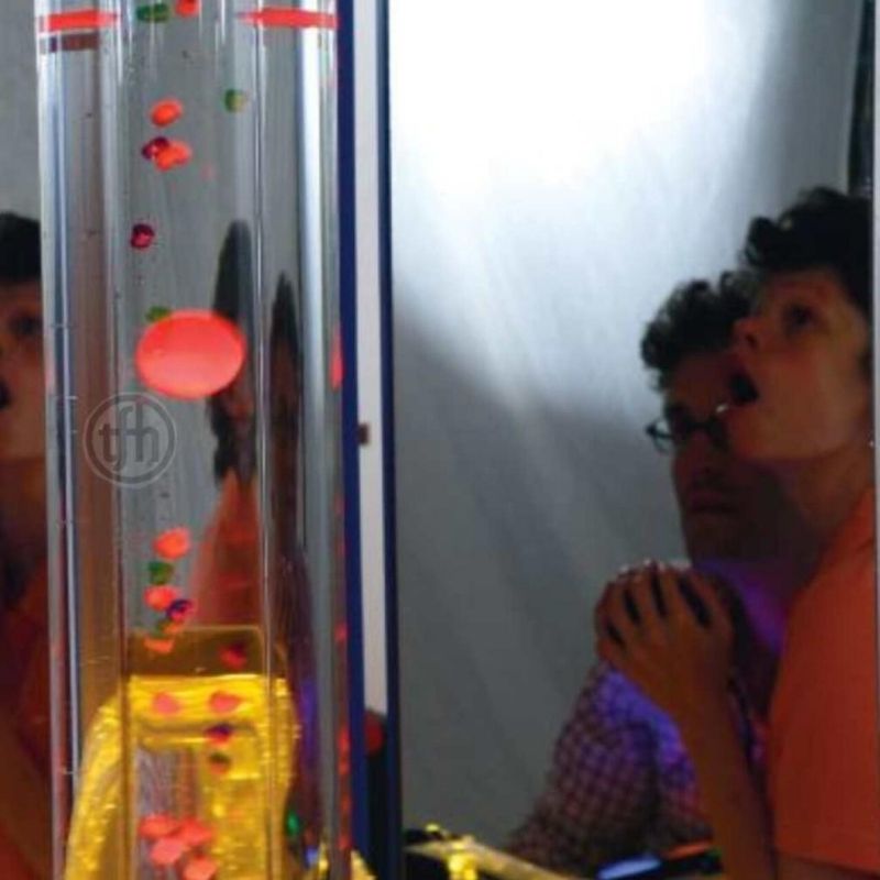 Child and adult watching the TFH Giant Bubble Tube Insert with cascading beads in a therapy room setting, supporting visual engagement and calm