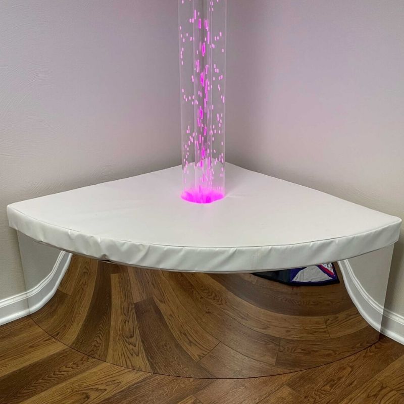 TFH Bubble Tube Corner Seat Base with bubble tube glowing pink, showing LED colour reflection through the mirrored podium base