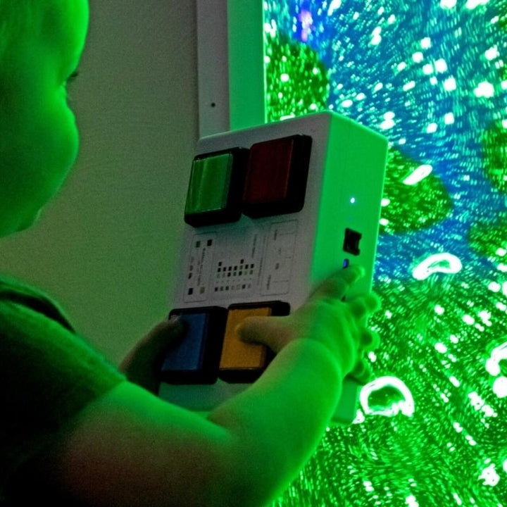 Child actively using a colour controller with the TFH Lights & Bubbles Water Panel, demonstrating interactive sensory bubble wall engagement