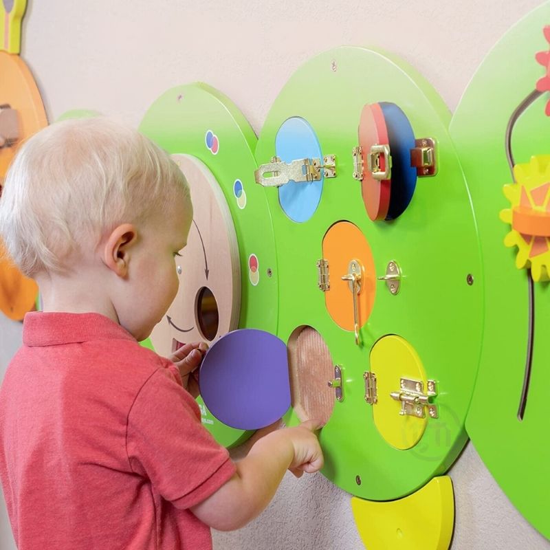 TFH Caterpillar Activity Wall Panel from an alternate angle showing the full wall-mounted sensory busy board with 8 hands-on activities across 5 colourful panels
