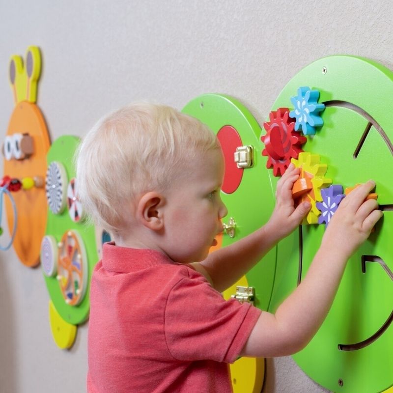 TFH Caterpillar Activity Wall Panel section showing interlocking cogs and lockable doors with textured surfaces for tactile discrimination and fine motor sensory play