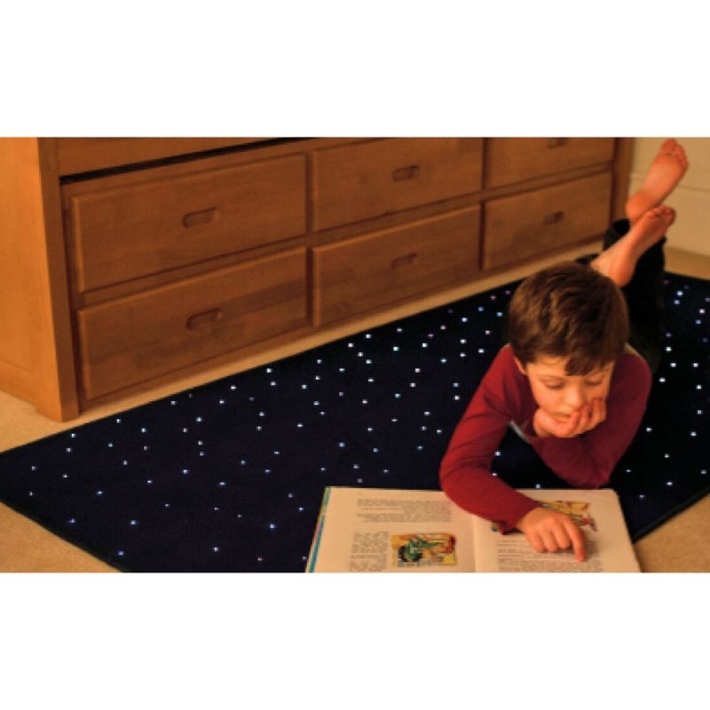 TFH Fibre Optic Carpet rectangle version in a room setting with a child actively playing on the sensory star carpet, demonstrating the dual visual and tactile sensory experience