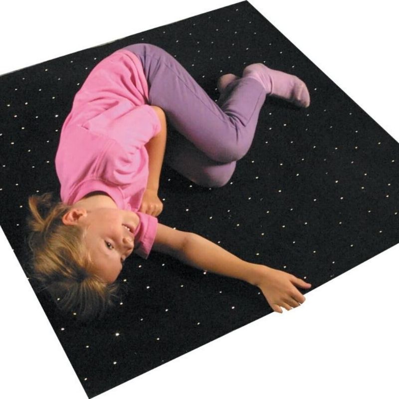 TFH Fibre Optic Carpet square version seen from above with a child actively playing on the sparkling sensory star carpet surface, showing the PMMA fibre optic light points glowing in colour