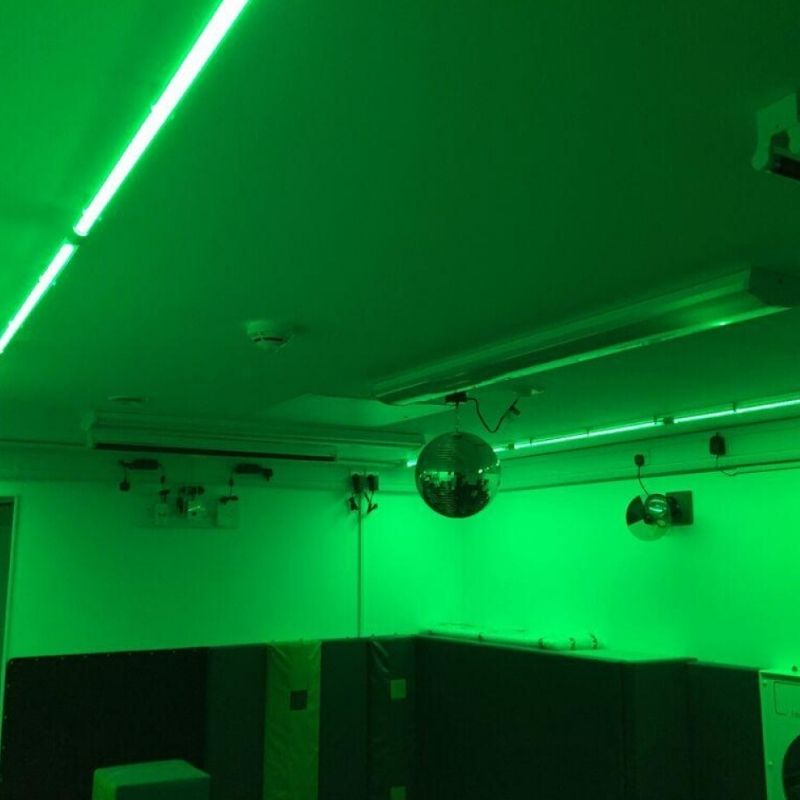 TFH Genie Colour Wash Kit illuminating a sensory room in green, demonstrating full-room LED colour wash lighting for therapy and educational spaces