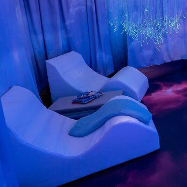 Two TFH Giant Foam Relax & Recline units side by side showing Junior and Regular/Senior size comparison, ergonomic foam recliners for teens and adults in sensory settings