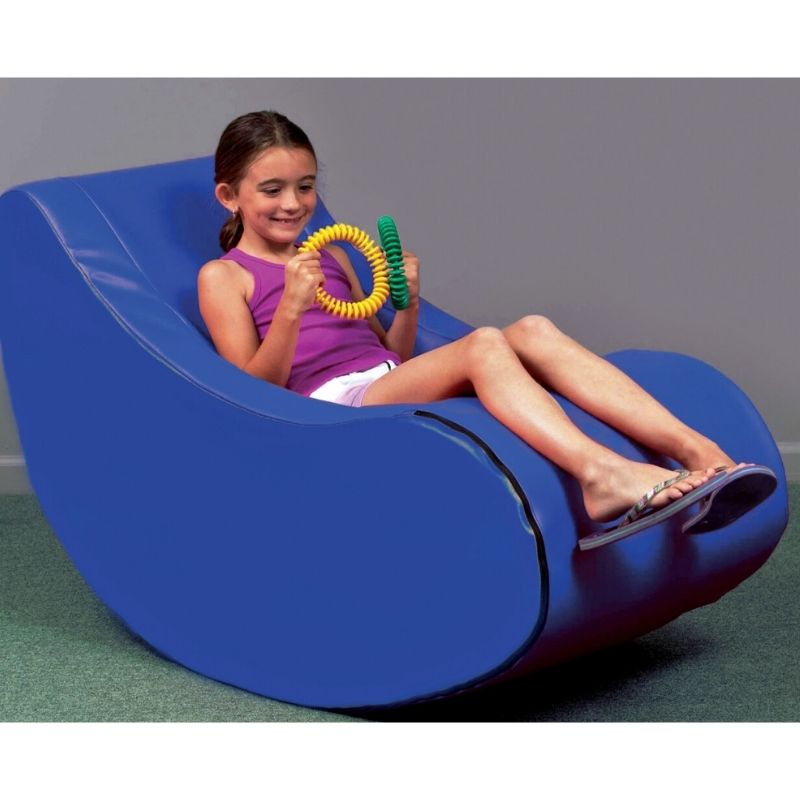 TFH Giant Foam Therapy Rocker with child in active play position, firm foam vestibular sensory rocking chair with arm rests for therapy rooms and sensory spaces