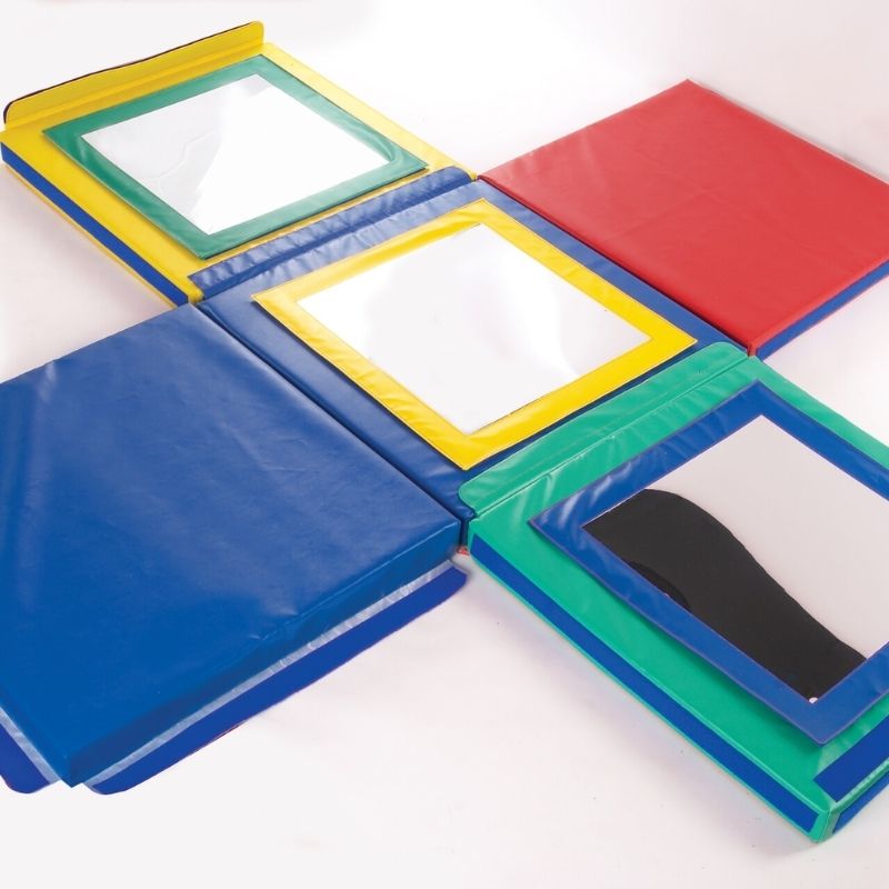 Top-down view of the TFH Giant Folding Mirror Den showing the 80cm cube interior layout with three removable coloured framed mirrors and two plain foam panels