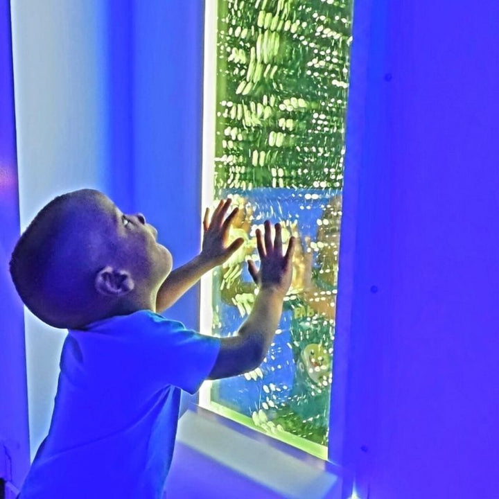 Baby interacting with the TFH Infinity Bubble Wall, exploring the colour-changing sensory light display for early visual stimulation and sensory development