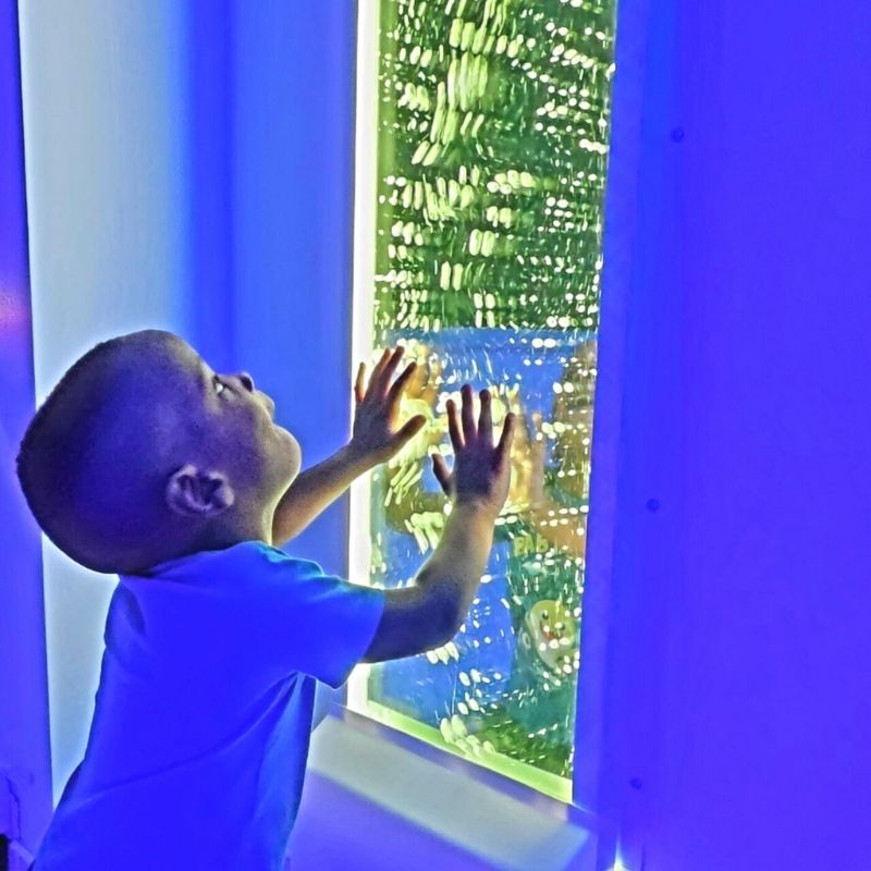 Baby interacting with the TFH Infinity Bubble Wall, exploring the colour-changing sensory light display for early visual stimulation and sensory development