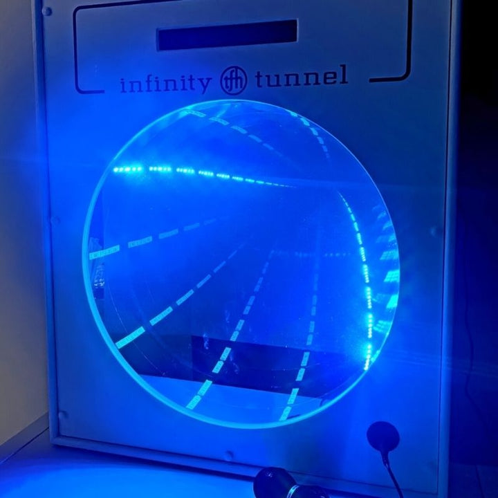 TFH Interactive Infinity Tunnel and Microphone front view glowing in blue, showing the colour-changing sound-sensitive LED optical illusion wall panel for sensory rooms