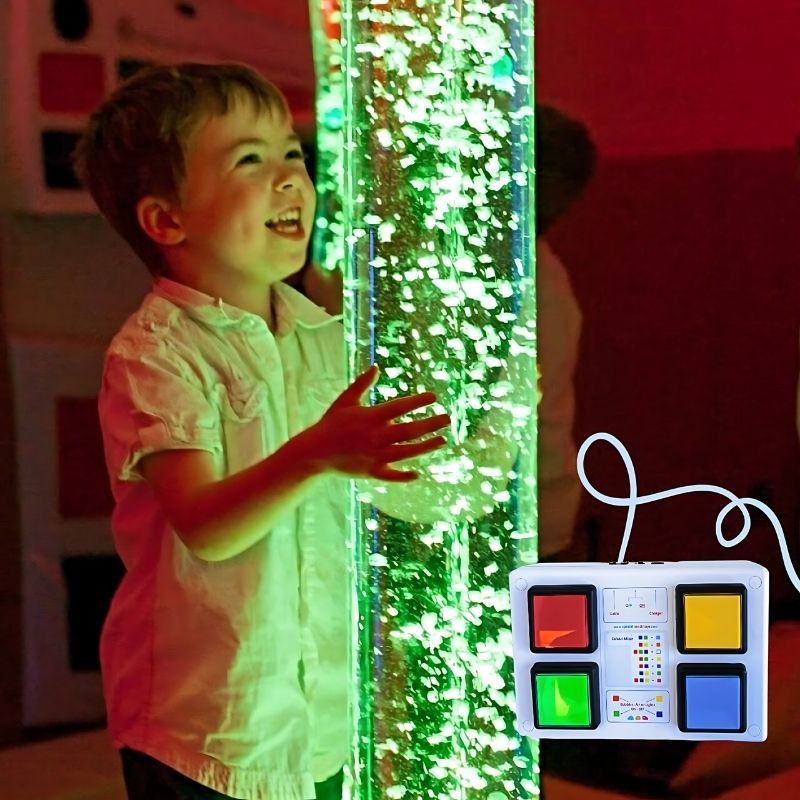 Child actively playing with the TFH Interactive LED Bubble Tube using the wired colour controller in a sensory room