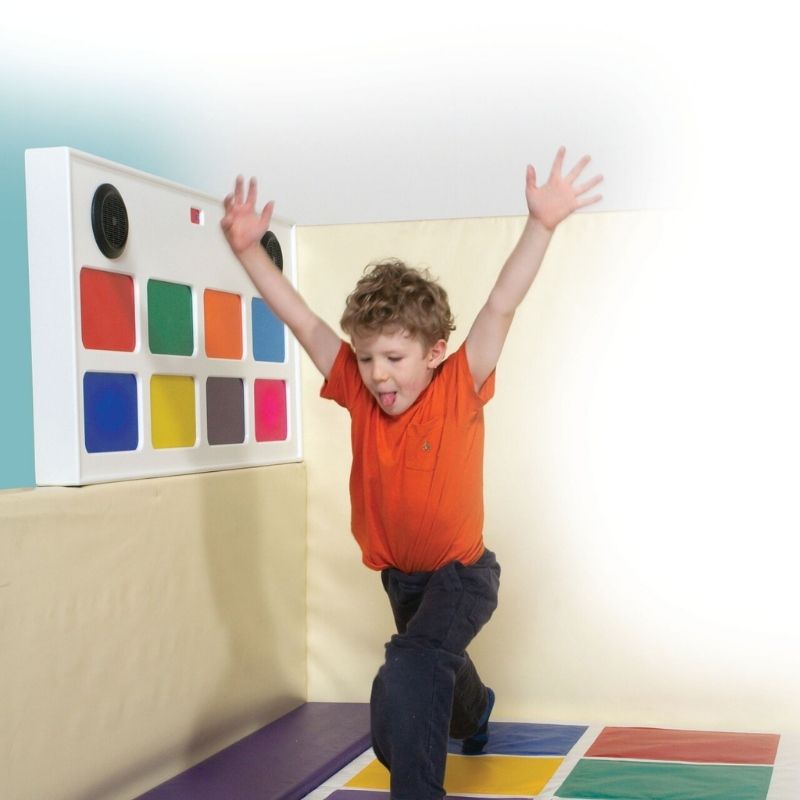 TFH Interactive Musical Squares with a child actively playing on the colour-lit touch squares, demonstrating cause-and-effect auditory and visual sensory engagement on the floor pad