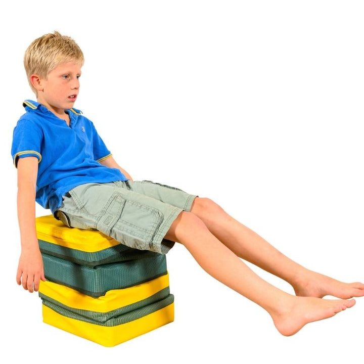 Boy seated on the TFH Jiggler Balance Seat Stool demonstrating active seating for core strength, coordination and proprioceptive sensory input