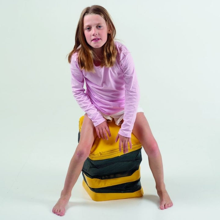 Girl seated on the TFH Jiggler Balance Stool showing active sitting posture with core engagement for focus and sensory regulation