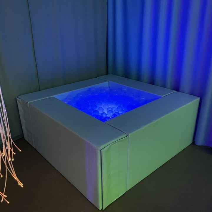 TFH Large Light-Up Ball Pit shown in full in an indoor sensory room setting with LED glow through 3000 translucent balls