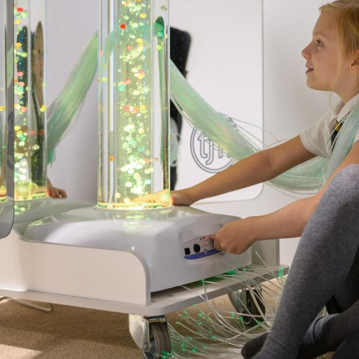 Girl engaging with the TFH Mobile Sensory Cart Deluxe bubble tube, exploring colour changes and visual sensory stimulation