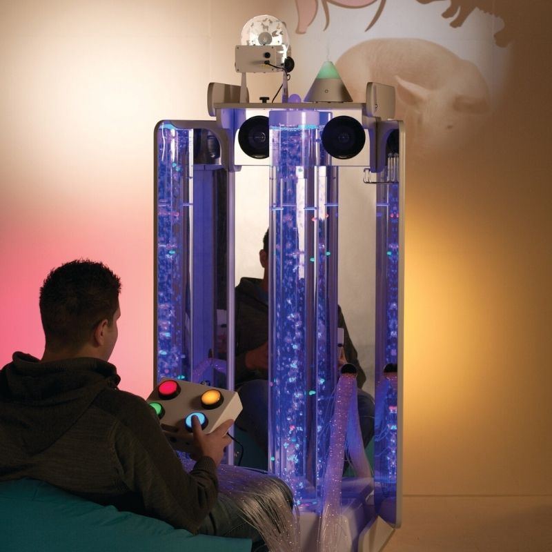 Adult user operating the 4-Button Colour Controller on the TFH Vecta Deluxe portable sensory station for cause-and-effect sensory work