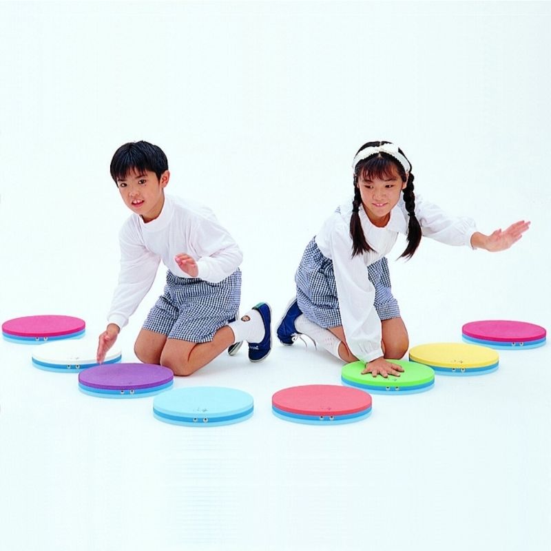 Two children playing together on TFH Musical Stepping Notes, demonstrating group sensory music activity with the acoustic stepping pad set