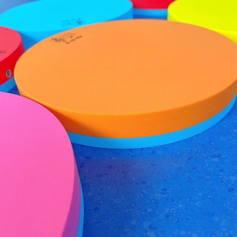 Landscape close-up view of the TFH Musical Stepping Notes acoustic floor pads showing the colourful diatonic octave stepping pad set