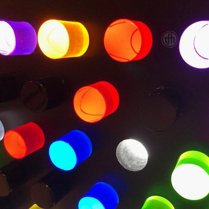 Close-up of the TFH Rod Wall Activity Panel showing the 144 colour-coded rods in red, green, purple, yellow, orange, blue, clear and black inserted in the dimmable LED-lit peg holes