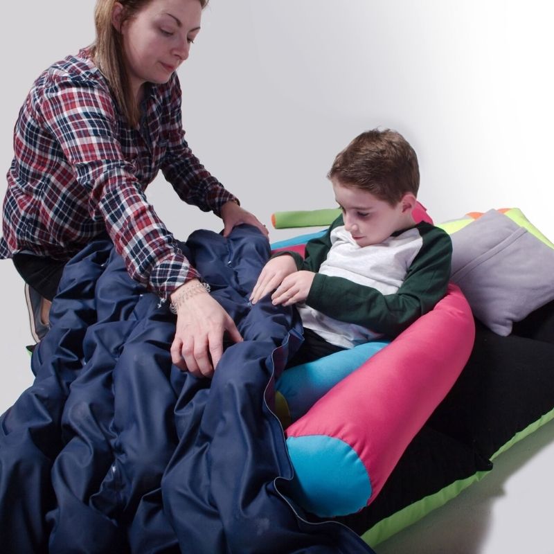 Adult and child together with the TFH Sensory Pressure Vinyl Ball Pad, showing therapeutic deep pressure use in a home or clinical sensory setting