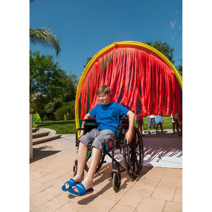 Boy actively playing in the TFH Giant Tickle Me Tunnel, developing gross motor skills and tactile sensory response
