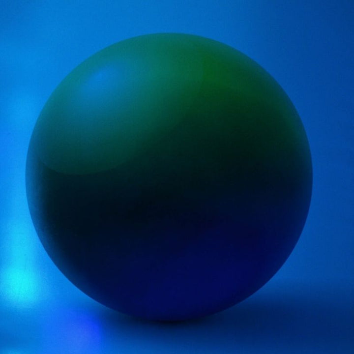 TFH Decorative Sensory Room Wall Padding Sphere design in blue sensory room light demonstrating the light-responsive colour transformation as the pad absorbs and shifts colour from the surrounding sensory environment