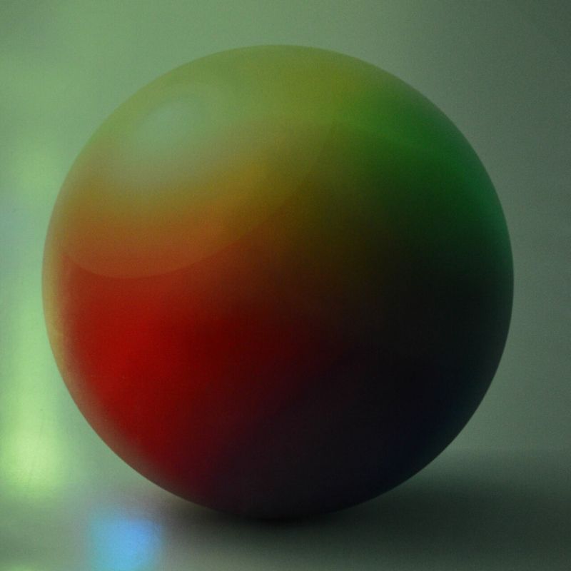 TFH Decorative Sensory Room Wall Padding Sphere design in green sensory room light, showing the 3D-effect light-responsive colour-shifting sphere wall pad reacting to room colour