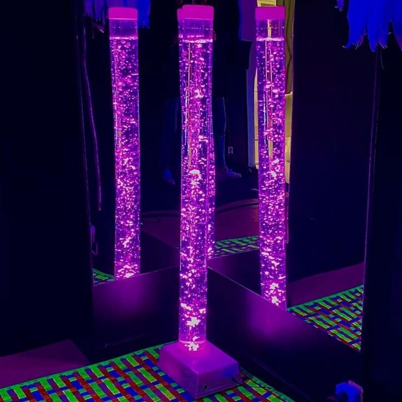 TFH Small Bubble Tube 4-inch wide standing in a corner sensory room with purple LED colour-changing light, a compact 48-inch sensory bubble column for bedrooms and home sensory spaces