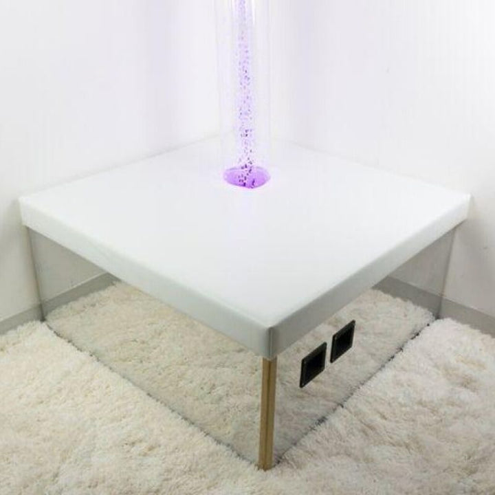 TFH Square Podium Base corner view showing the full 36-inch square padded mirrored podium with bubble tube installed as part of the TFH Modular Sensory Room System