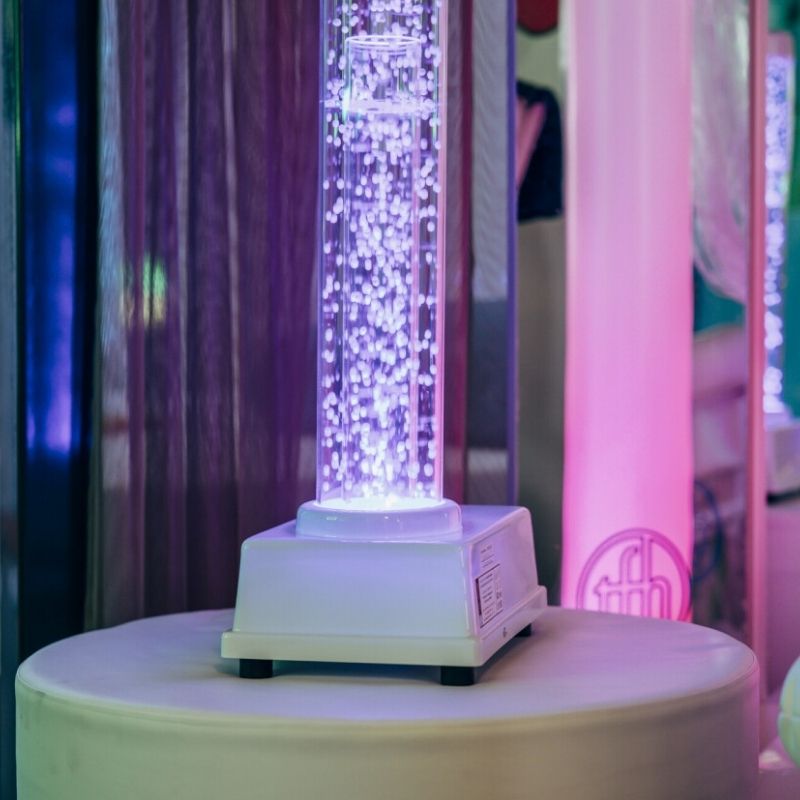 Close-up detail of fan-driven styrofoam beads and LED colour transitions inside the TFH Tabletop Hurricane Tube, the waterless portable sensory tube alternative to bubble tubes