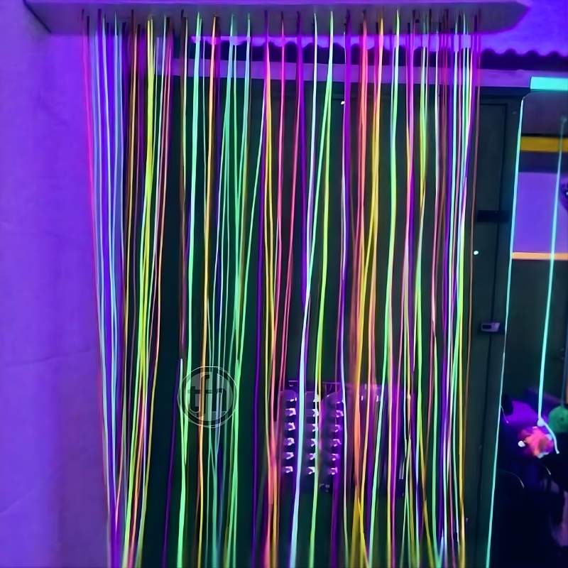 TFH UV Fiber Optic Curtain with Light Source mounted on a wall, showing 100 UV-reactive fibre optic tails cascading in a darkened sensory room