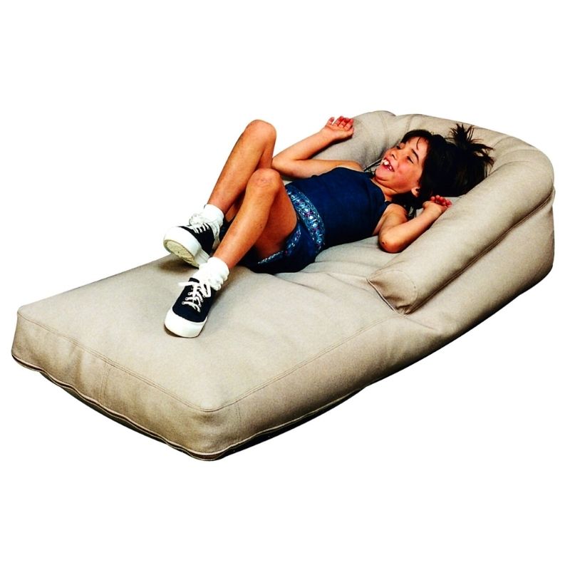 TFH Vibroacoustic Long Easy Floor Lounge with a child lying down in active play, showing the full-length foam vibroacoustic therapy lounger in use for floor-level proprioceptive sensory input