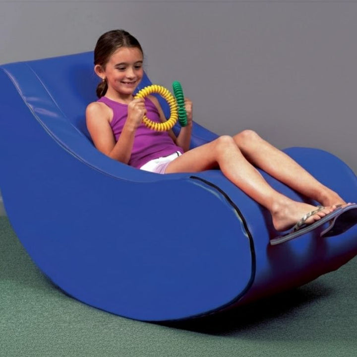 TFH Vibroacoustic Therapy Rocker in use with a child, showing the sensory rocking chair providing dual vestibular and vibroacoustic proprioceptive input for children in therapy rooms and sensory spaces