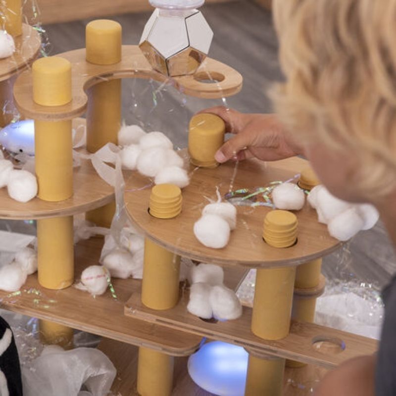 Detailed view of TTS Alice Sharp Eco Build a World individual loose parts pieces including bamboo bases, tube connectors, and recycled plastic joiners from the 86-piece set