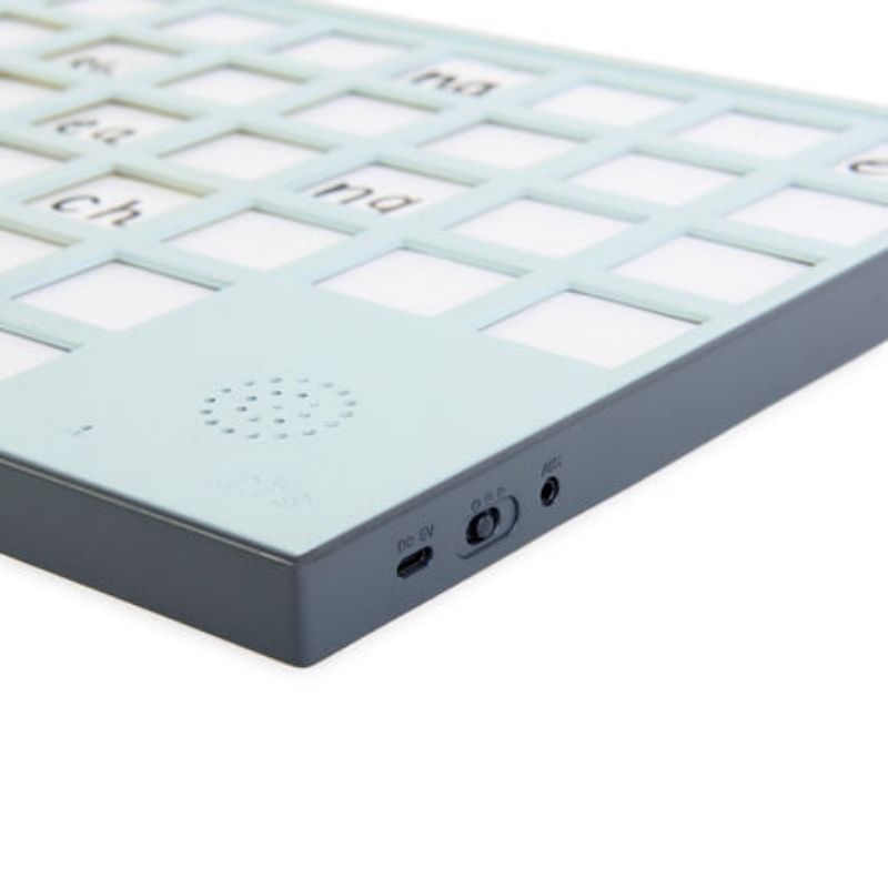 Close-up of the TTS A3 Chatter Board Pro bottom edge showing the built-in speaker, USB charging port, and headphone socket for private listening during communication activities