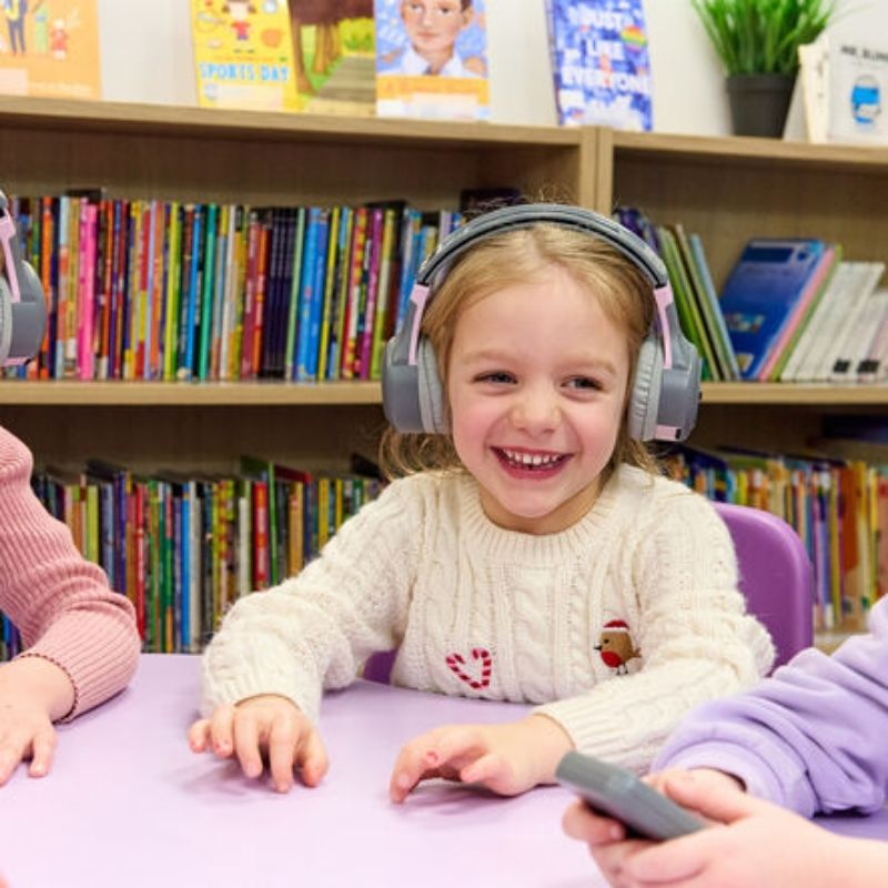 Six TTS ClassCast rechargeable headsets arranged for classroom use, each offering 8 hours of battery life for group listening and oracy activities
