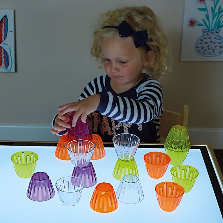 TTS Clever Cups arranged in a sorting and colour activity for early years STEM learning on a light panel