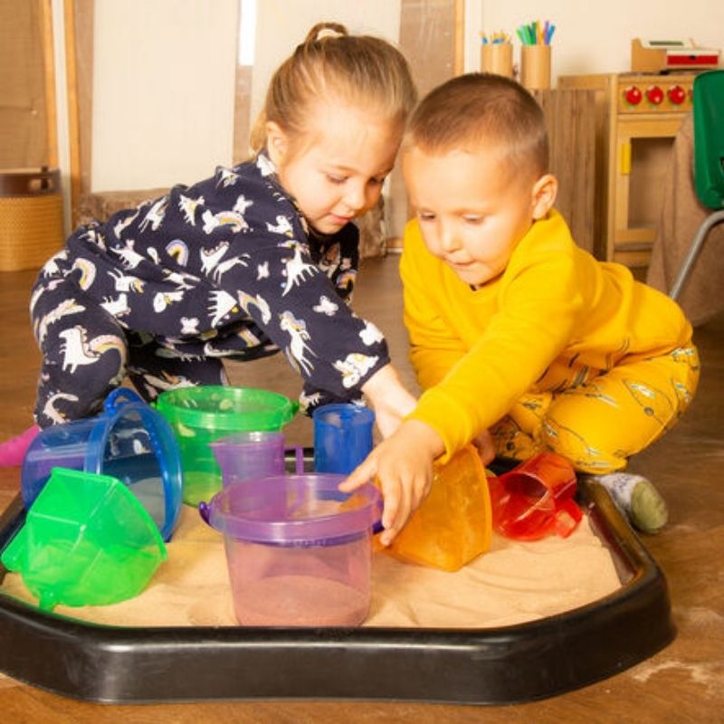 Children playing together with TTS Translucent Colour Buckets in sand, fostering collaborative sensory exploration and early learning across all abilities