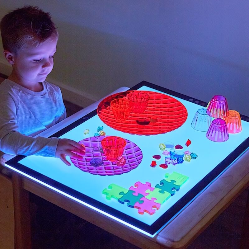 TTS Colour Changing Light Panel in use with a child seated, exploring the LED light surface for sensory and visual learning