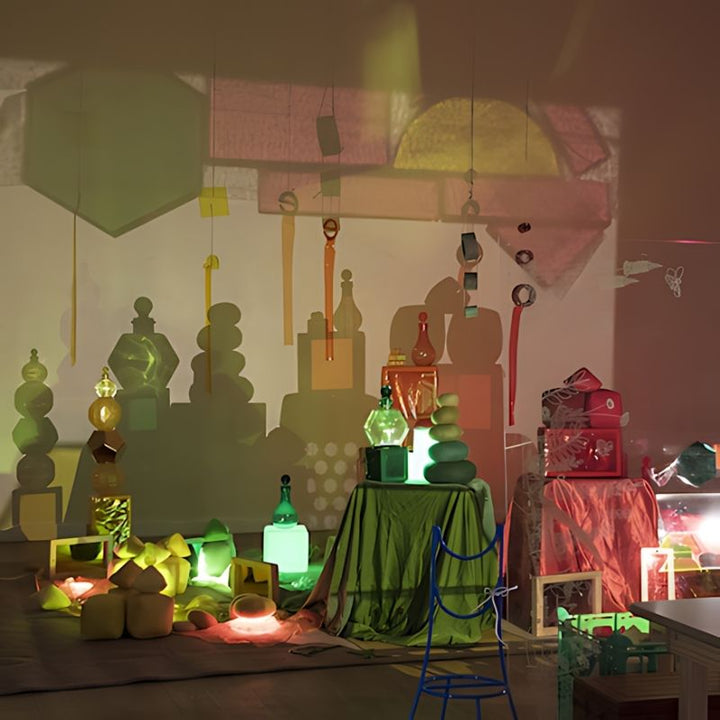 TTS Early Years Projector used in a large collaborative light installation, layering shadows and coloured light from multiple objects onto walls and ceiling in an early years or therapy setting