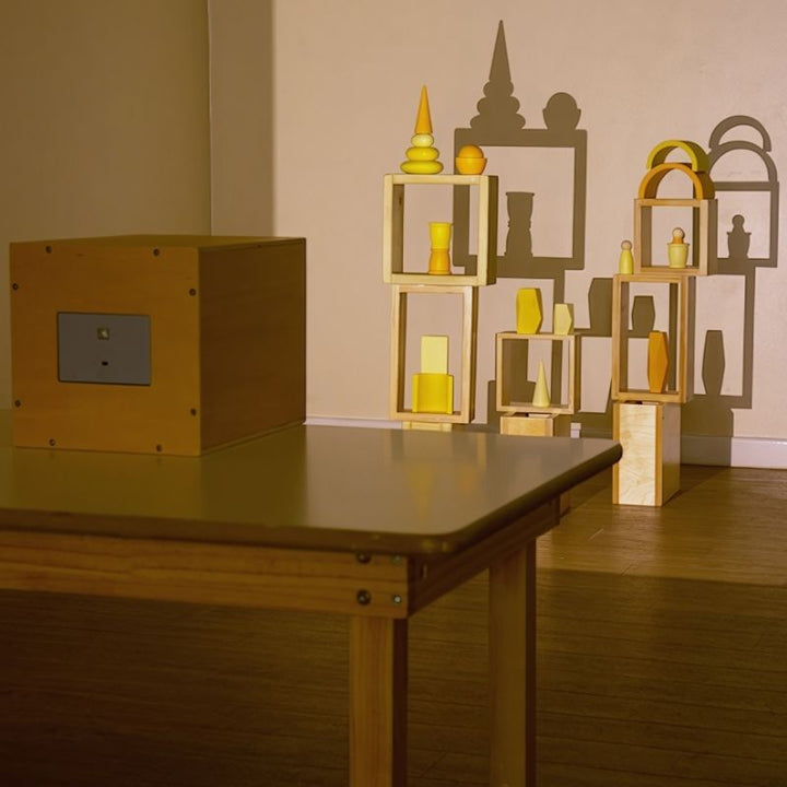 TTS Early Years Projector on a classroom table casting large shadow projections of wooden shapes and objects, supporting visual perception and STEAM learning for children aged 3 and up