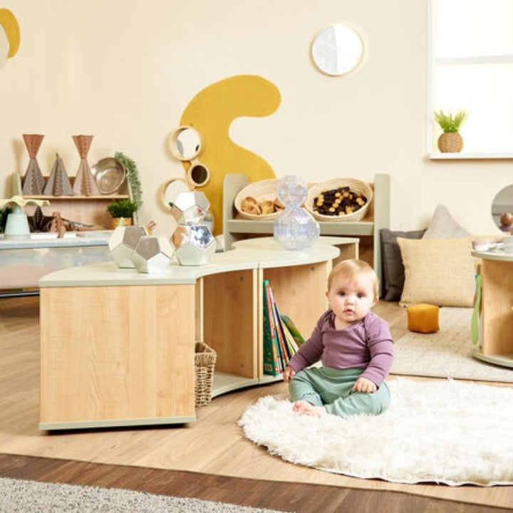 Child engaging with TTS Elements Sage Toddler Curved Storage Unit in an early years play space, supporting independent exploration
