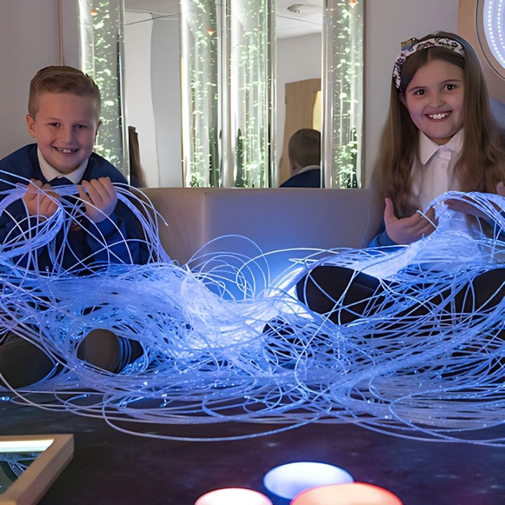 Two children exploring TTS Fibre Optic Tails together, illustrating the inclusive visual and tactile sensory experience