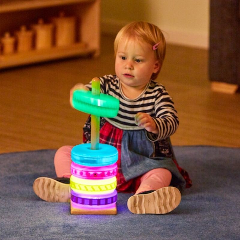 TTS Glow Stacking Discs illuminated and glowing, demonstrating the shake-activated light display used in sensory rooms and early years classrooms